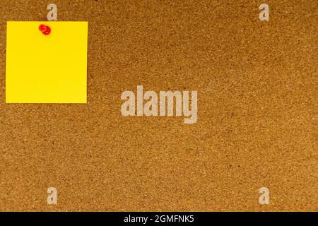 Abstract paper note pinned to a cork board. Bulletin board with empty space for add text message. Stock Photo