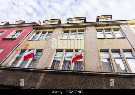 POZNAN, POLAND - Nov 12, 2018: The Polish flags on old buildings in the city square of Poznan, Poland Stock Photo