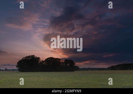 Clouds illuminated by the light of the setting sun. Stock Photo