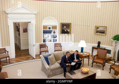 President Barack Obama confers with Director of Speechwriting Jon Favreau in the Oval Office, Sept. 17, 2010. (Official White House Photo by Pete Souza) This official White House photograph is being made available only for publication by news organizations and/or for personal use printing by the subject(s) of the photograph. The photograph may not be manipulated in any way and may not be used in commercial or political materials, advertisements, emails, products, promotions that in any way suggests approval or endorsement of the President, the First Family, or the White House. Stock Photo