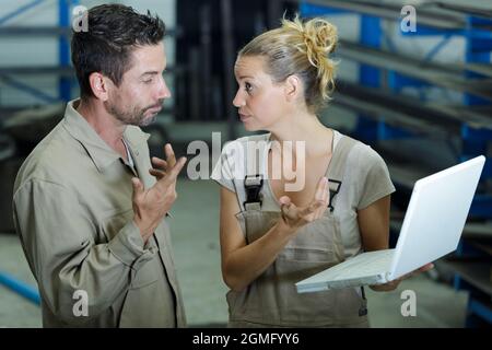 portrait of two warehouse workers doing inventory of stock Stock Photo
