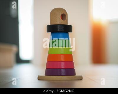 Multicolored wooden toy pyramid On the wooden floor Stock Photo