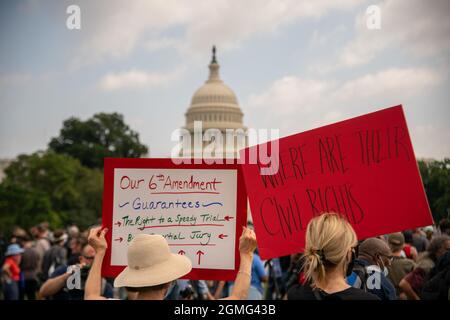 Washington, USA. 18th Sep, 2021. Protesters hold signs at the 'Justice for J6' rally, a protest of the treatment of those arrested on January 6th during the storming of the U.S. Capitol, in Washington, DC on September 18, 2021. (Photo by Matthew Rodier/Sipa USA) Credit: Sipa USA/Alamy Live News Stock Photo