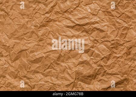 Ragged crumpled brown kraft paper seamless texture and full frame flat background. Stock Photo