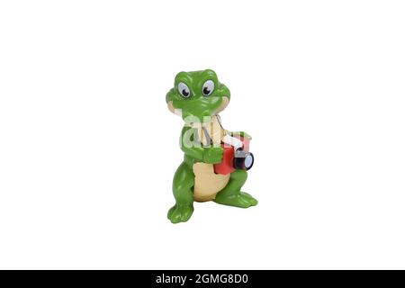 Toy cartoon crocodile figurine with a camera on a white background under clipping Stock Photo