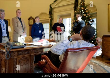 President Barack Obama meets with advisors prior to his phone call with Russian President Dmitry Medvedev in the Oval Office, Dec. 12, 2009. (Official White House Photo by Pete Souza) This official White House photograph is being made available only for publication by news organizations and/or for personal use printing by the subject(s) of the photograph. The photograph may not be manipulated in any way and may not be used in commercial or political materials, advertisements, emails, products, promotions that in any way suggests approval or endorsement of the President, the First Family, or th Stock Photo