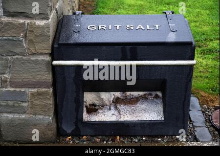 Salt grit black container for winter road safety on council road Stock Photo