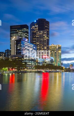 A night view of Melbourne, Australia, seen from the Yarra River with Southbank highrise landmarks.