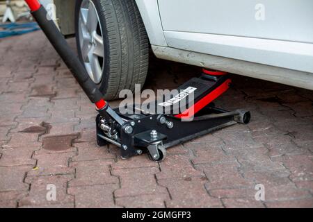 Tire change of a car. placing a jack under the car Stock Photo