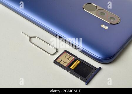 phone with sim ejector and and sim tray on white background Stock Photo