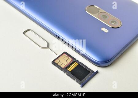 phone with sim ejector and memory card on white background Stock Photo