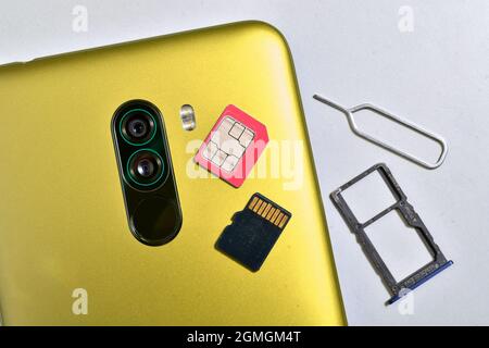 Smartphone with sim, memory card, sim tray and sim ejector pin Stock Photo