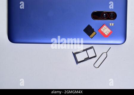 Smartphone with memory card, sim tray, sim and sim ejector tool Stock Photo