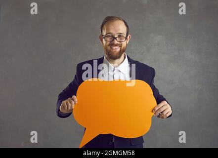 Happy smiling business man with speech bubble standing on studio copy space Stock Photo