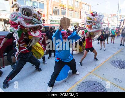 Toronto, Canada. 18th Sep, 2021. People perform a lion dance at the Chinatown in Toronto, Canada, on Sept. 18, 2021. A traditional lion dance parade was held here on Saturday to celebrate the upcoming Mid-Autumn Festival. Credit: Zou Zheng/Xinhua/Alamy Live News Stock Photo