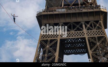 Paris, France. 18th Sep, 2021. French highliner Nathan Paulin performs on a 70-meter-high slackline spanning 670 meters between the Eiffel Tower and the Theater National de Chaillot in Paris, France, on Sept. 18, 2021. Credit: Xinhua/Alamy Live News Stock Photo