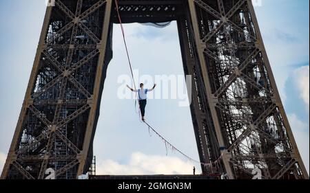Paris, France. 18th Sep, 2021. French highliner Nathan Paulin performs on a 70-meter-high slackline spanning 670 meters between the Eiffel Tower and the Theater National de Chaillot in Paris, France, on Sept. 18, 2021. Credit: Xinhua/Alamy Live News Stock Photo