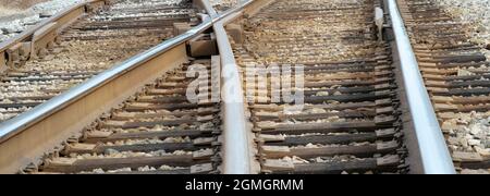 Train rail intersection on sunny day Stock Photo