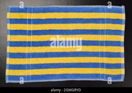 Top View of Striped Towel on black Background Stock Photo