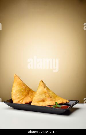 Indian and Pakistani food potato samosa with tomato sauce Stock Photo