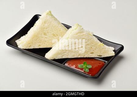 sandwiches with sauce in Black plate isolated on white background Stock Photo