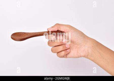 Empty Wooden Spoon in Hand Stock Photo