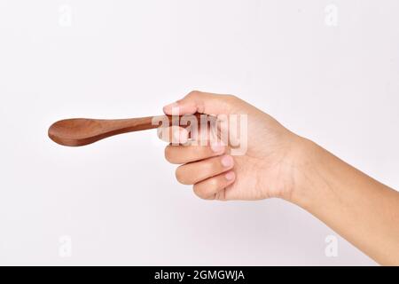 Empty Wooden Spoon in Hand Stock Photo