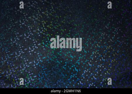 Colorful rainbow holographic dots on dark, silver and grey background; magic color light effect Stock Photo