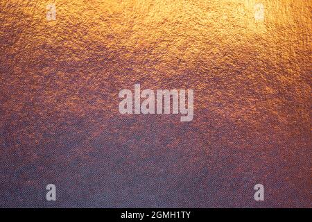 Textured metallic gold background with light and dark highlights, bright and shiny golden metal texture Stock Photo