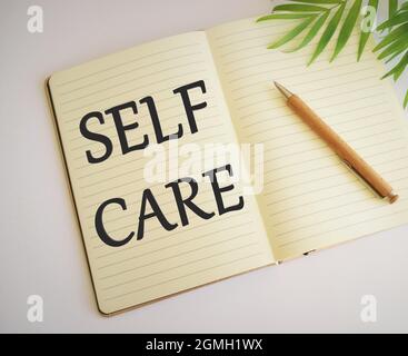 Self care inspirational reminder written in Notebook, Conceptual hand writing showing Self care. Business photo text focused on own well-being and hap Stock Photo