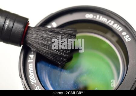 Removing dust from lens, Cleaning Camera Lens with Brush Stock Photo