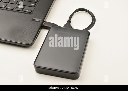 External Hard Drive Connected to Laptop Stock Photo