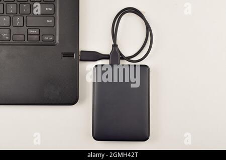 Top View of External Hard Drive Connected to Laptop Stock Photo