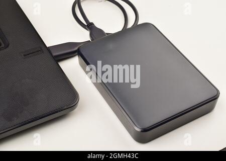 External  Hard Drive Connected to Laptop Stock Photo