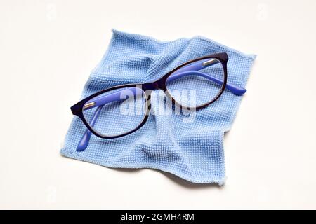 Eyesight Glasses with microfiber cloth over white background, eyewear  cleaning cloth Stock Photo