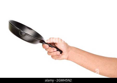 Cast iron skillet in hand isolated on white background, Hand Holding Empty Cast Iron Skillet Stock Photo