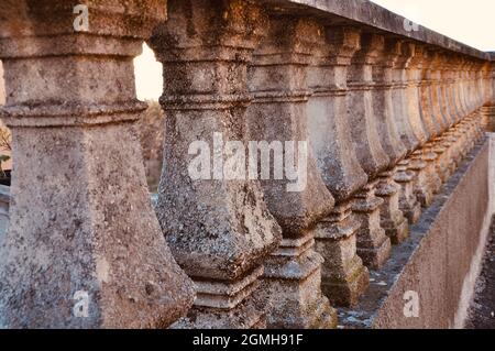 Perspective wiev of balustrade in the park.Old stone fence Stock Photo