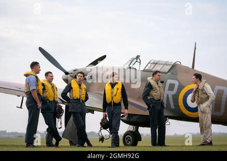 Spirit of Britain living history group stand by a Hawker Hurricane on the flightline during the Battle of Britain Air Show at IWM Duxford. Picture date: Sunday September 19, 2021. Stock Photo