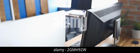 Many computers standing on table in empty classroom Stock Photo