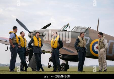 Spirit of Britain living history group stand by a Hawker Hurricane on the flightline during the Battle of Britain Air Show at IWM Duxford. Picture date: Sunday September 19, 2021. Stock Photo