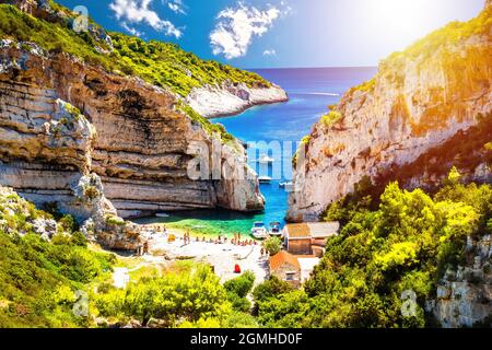 Scenic Stiniva beach on island of Vis sun haze view, Dalmatia archipelago of Croatia Stock Photo