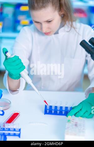 Young female laboratory assistant in laboratory analyzing environmental pollution Stock Photo
