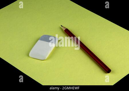 Eraser and pencil with sheet of coloured paper Stock Photo