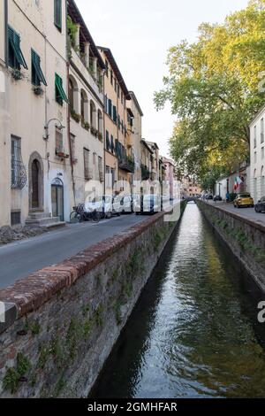 Lucca, Italy - august 21 2021 - medieval street with narrow channel in the middle Stock Photo