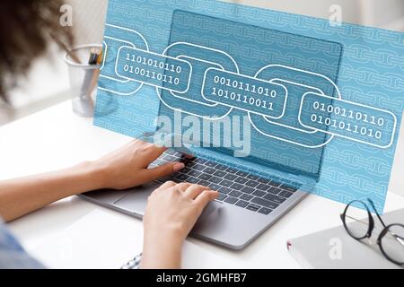 Cropped young black female, modern worker programmer working on computer with binary code Stock Photo