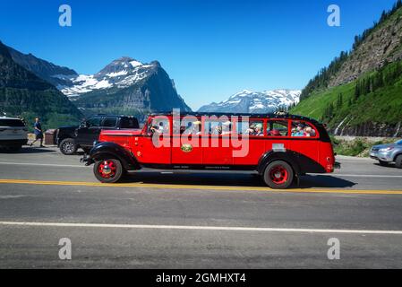 GLACIER NATIONAL PARK, MT - JUNE 28, 2021: Tourists ride a bus through Glacier National Park in Montana Stock Photo