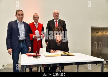 17 September 2021, North Rhine-Westphalia, Cologne: The physicians Ugur Sahin (r) and Özlem Türeci. Cologne honors the Biontech founders in the city hall. The two researchers sign the city's Golden Book and the University of Cologne awards them an honorary doctorate. Photo: Horst Galuschka/dpa Stock Photo