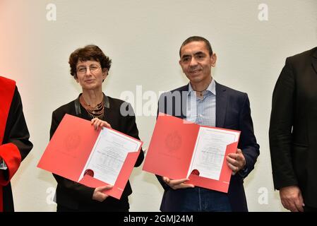 17 September 2021, North Rhine-Westphalia, Cologne: The physicians Ugur Sahin (r) and Özlem Türeci. Cologne honors the Biontech founders in the city hall. The two researchers sign the city's Golden Book and the University of Cologne awards them an honorary doctorate. Photo: Horst Galuschka/dpa Stock Photo