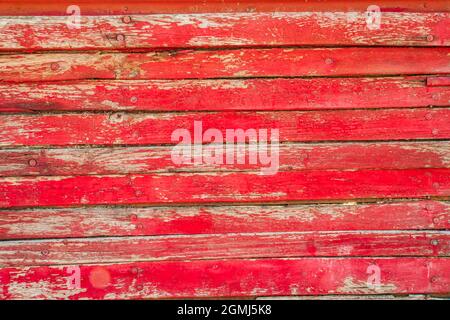 old red painted and peeling barn wooden boards Stock Photo
