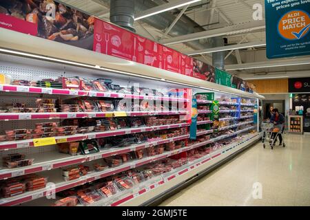 Taplow, UK. 19th September, 2021. The meat isle. Sainsbury's Supermarket had a good supply of food in their store today. Some lines are still being impacted upon by supply chain issues including bottled water and carbonated drinks such as cola due a shortage of carbon dioxide. This may lead to meat running short in supermarkets as animals are stunned before being slaughtered using carbon dioxide. Credit: Maureen McLean/Alamy Live News Stock Photo